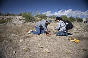 Jason Daniell (left) and a fellow student learn to lay out a 10-meter by 10-meter unit for excavation at the simulated archaeology site at West Campus.