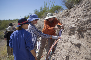 Faculty Tineke Van Zandt (center) explains to Chris La Roche (right) and another student how to profile rock layers at the simulated archaeology site at West Campus.